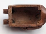 a small wooden object that is sitting on a table