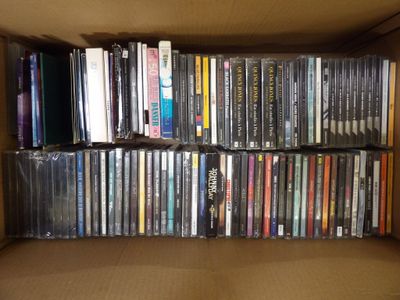 a box full of dvds and cds on a shelf