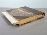 an old book that is sitting on top of a table