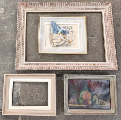 three framed pictures on the ground next to each other