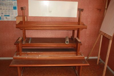 a wooden bench with a mirror on it in a room