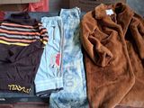 two pieces of clothing that are sitting on top of a suitcase