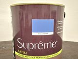 a close up of a paint can on a wooden table