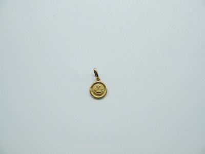 a close up of a gold coin on a white surface