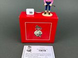 toy figurine of a man standing on top of a red box
