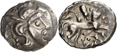 a silver coin with an image of a horse on it