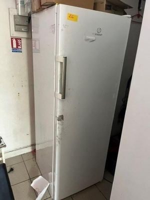 a white refrigerator in the corner of a kitchen