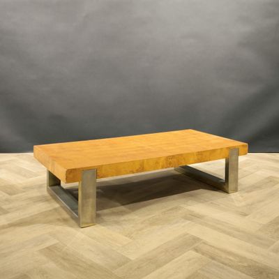 a wooden coffee table sitting on top of a wooden floor