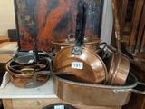 pots and pans sitting on a table with a painting in the background