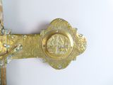 a gold cross with a picture of a man on it