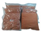 three bags filled with brown pillows sitting on top of a white surface
