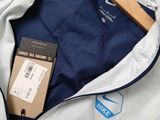 a white jacket with a blue jacket and a tag on it