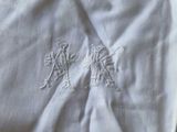 a pile of white towels sitting on top of a table