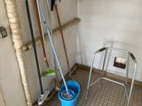 a mop and bucket in the corner of a room