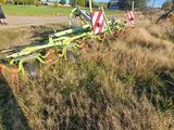 a tractor with a plow attached to it in a field