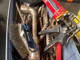 a bin full of tools that are sitting on the floor
