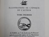 an open book with a black and white image of a boat