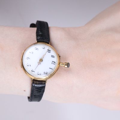 a woman ' s wrist that has a watch on it