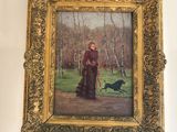 un tableau représentant une femme avec un chien, accroché au mur