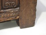 a close up of a wooden bench with carvings on it