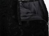 a close up of a black lace dress with a zipper on the back