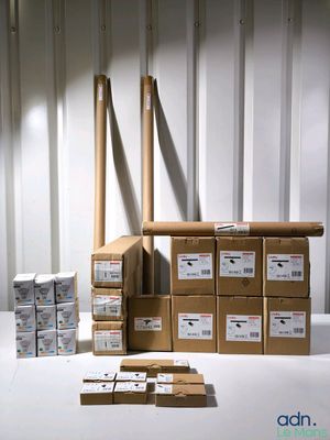 many boxes of mail sitting on a table in a storage room