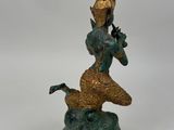 bronze statue of a person riding a horse with a bird on its back