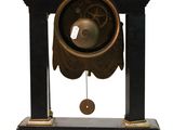 a clock that has a bell on top of it