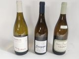 three bottles of wine sitting next to each other on a table