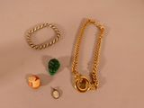 a necklace, bracelet, and ring laying on a table