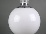 a white glass table lamp with a metal base and a white glass shade
