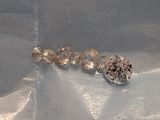 a group of three different colored diamonds on a blue cloth