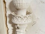 a white statue of a fire hydrant on the wall