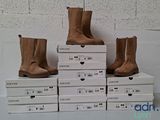several boxes of shoes are stacked on top of each other