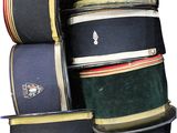 many hats stacked on top of each other on a table