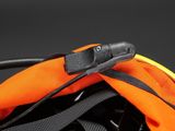 an orange backpack with a black handle and a black strap
