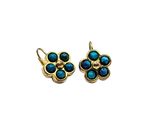 a pair of turquoise and gold earrings on a white background