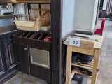 a kitchen with a stove, sink, oven, and cabinets