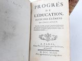 someone is holding a book open to a page with an image of a map on it