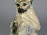 an image of a monkey figurine on a gray background