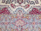 an antique persian rug with a floral design on a blue ground