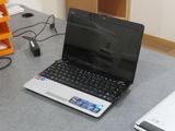 a laptop computer sitting on a table with a mouse on it