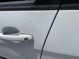 a close up of a door handle on a white car