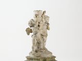 statue of a woman holding a child on a pedestal on a white background