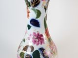 a glass vase with a floral design on it