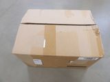 a cardboard box sitting on the floor in a room