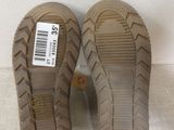 pair of tan shoes with a price tag on them sitting on a white surface