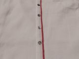 the skirt is white with red trim and buttons on the side