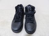 pair of black sneakers with black laces on a white surface