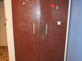 two brown doors in the hallway of a building